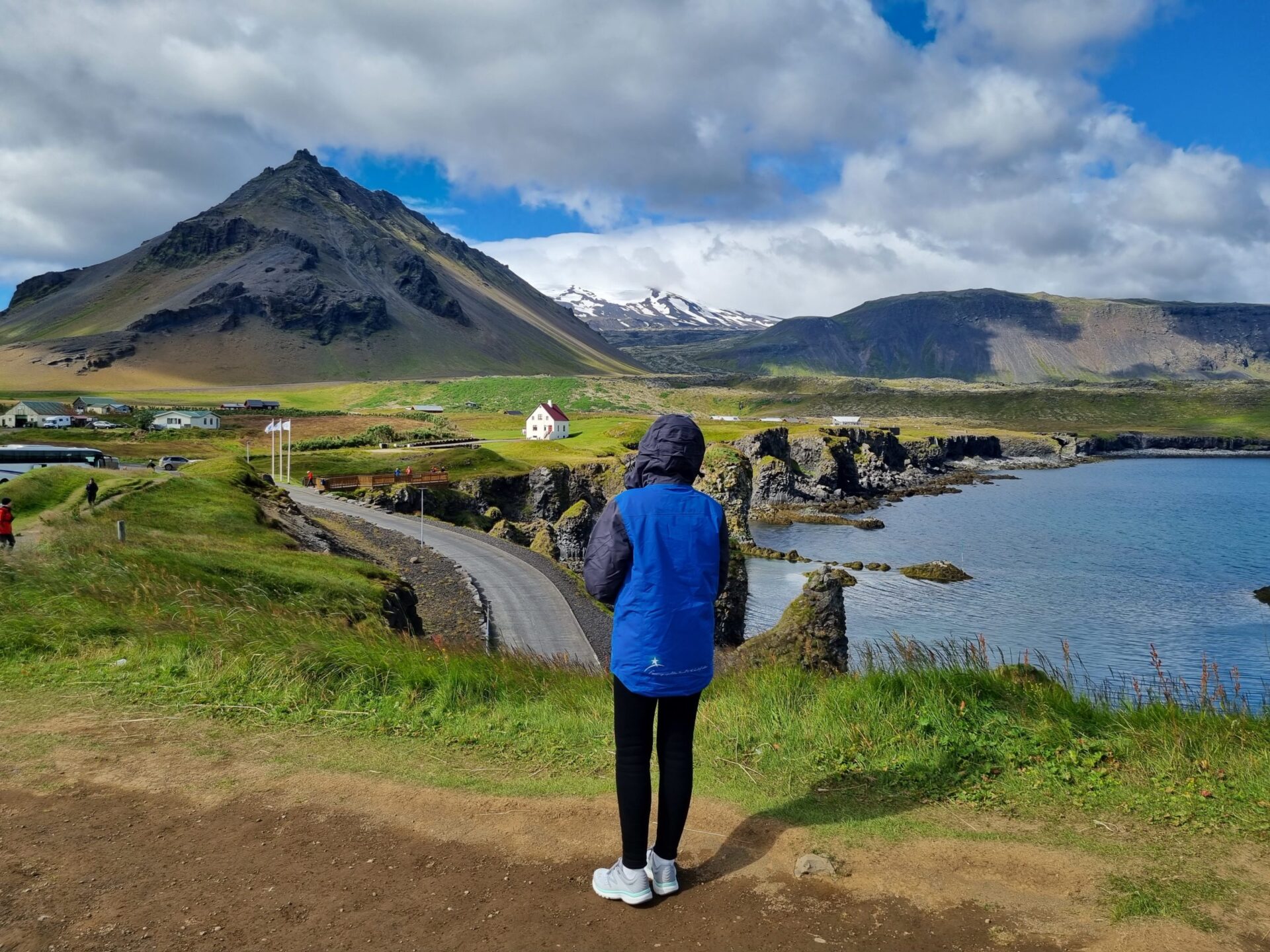 Expeditioner admiring the town of Arnastarpi in West Iceland