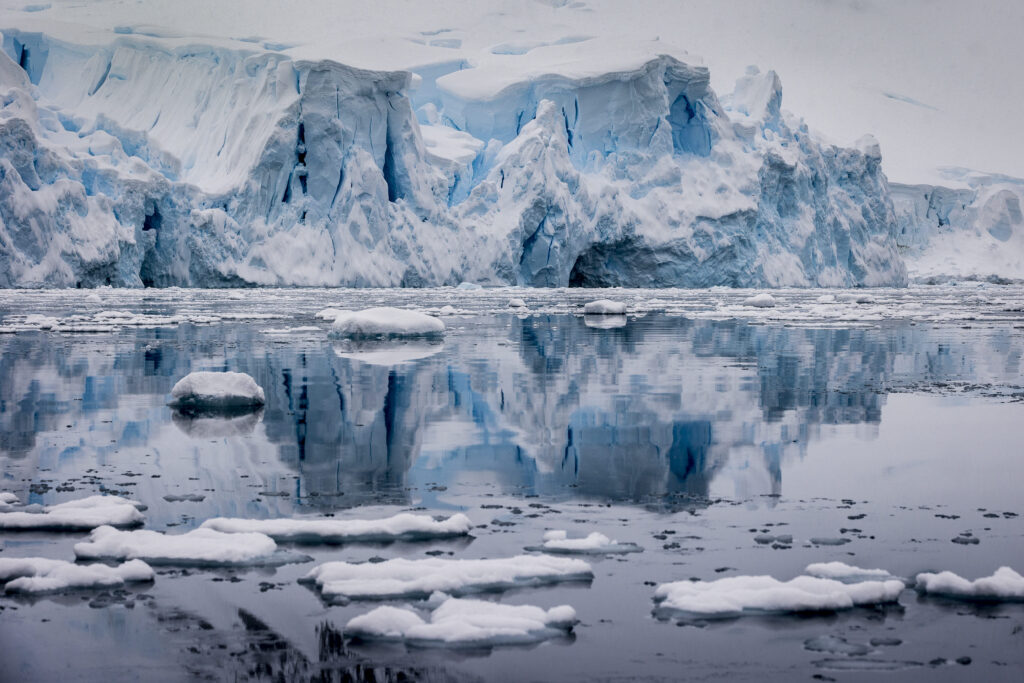 Glacier reflected in the waters of Paradise Harbour, Graham Land, Antarctica, Richard I'Anson