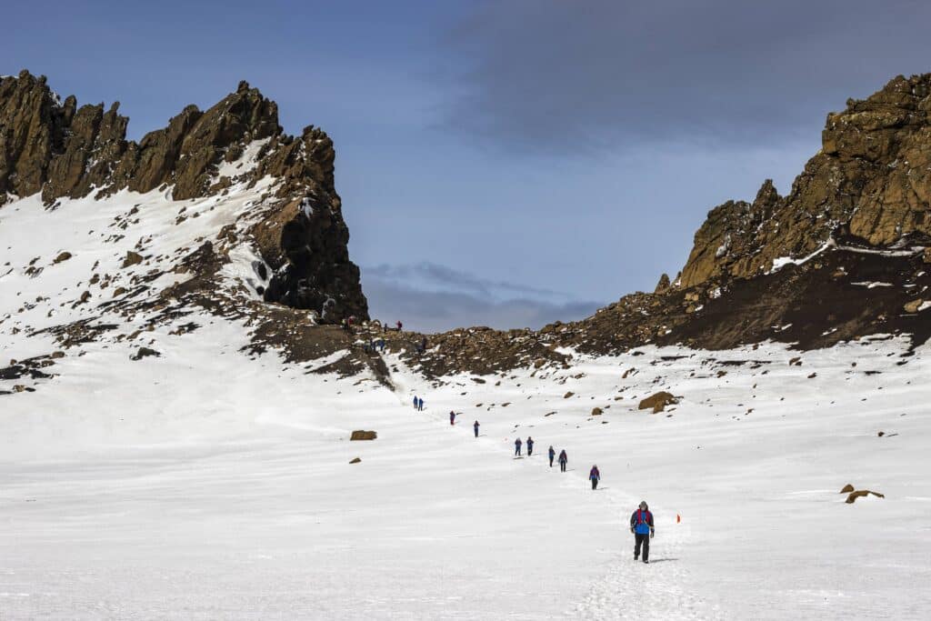 Passengers walking down from vantage point in Antarctica